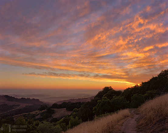 Sunset Over Hills and Distant Fog